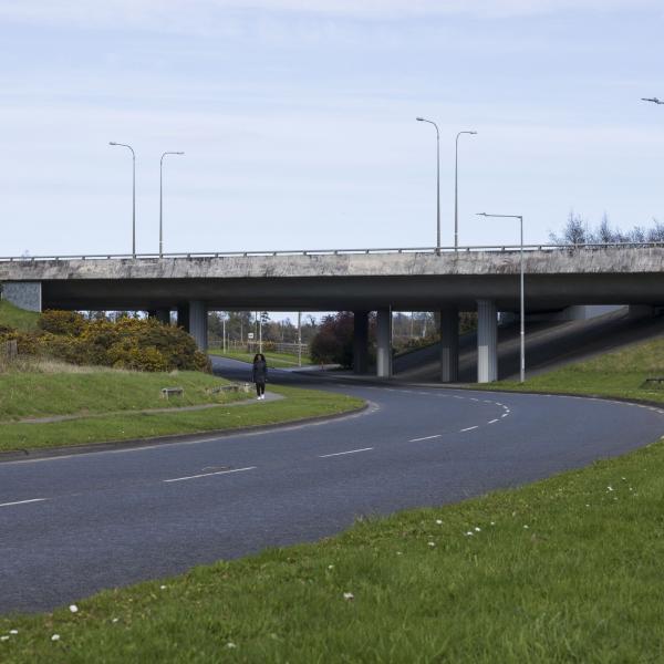 motorway overpass viewed from below with road running under it