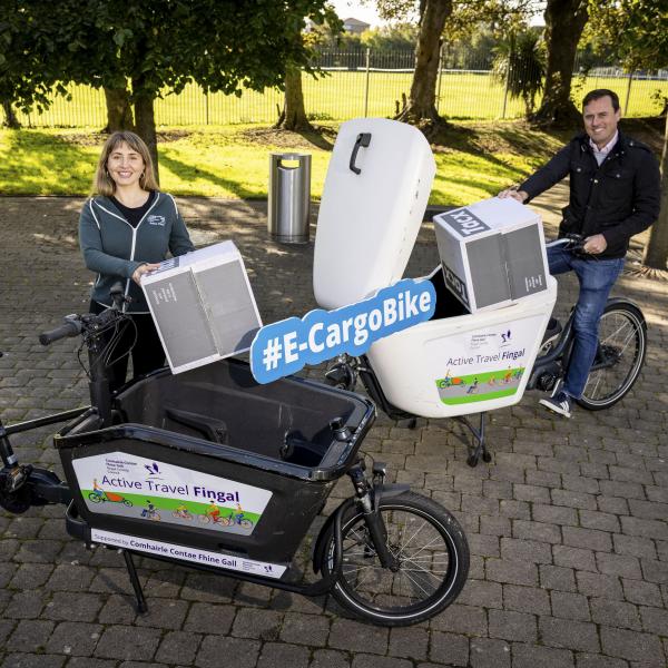 man and woman with ecargo bike each outdoors