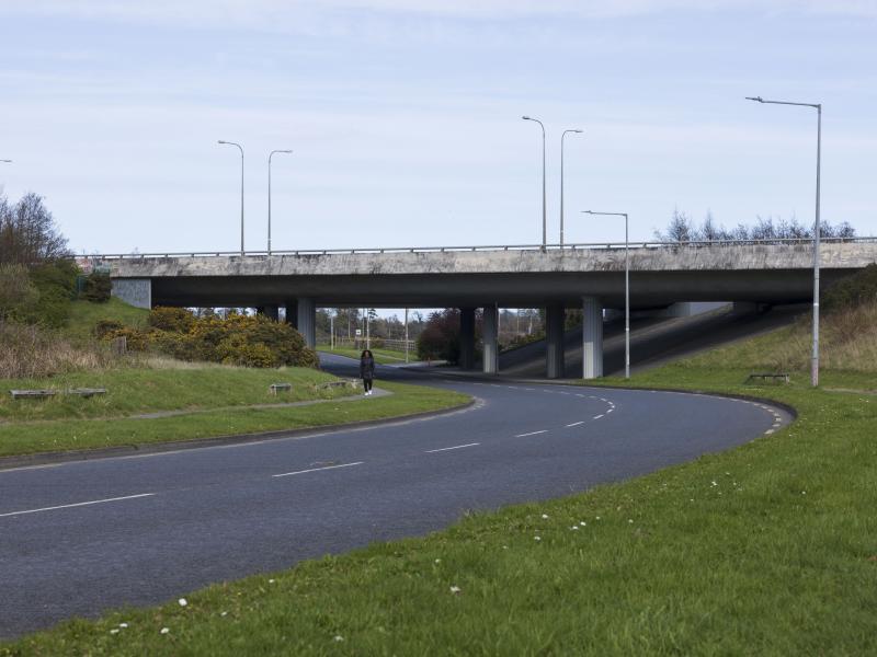 motorway overpass viewed from below with road running under it