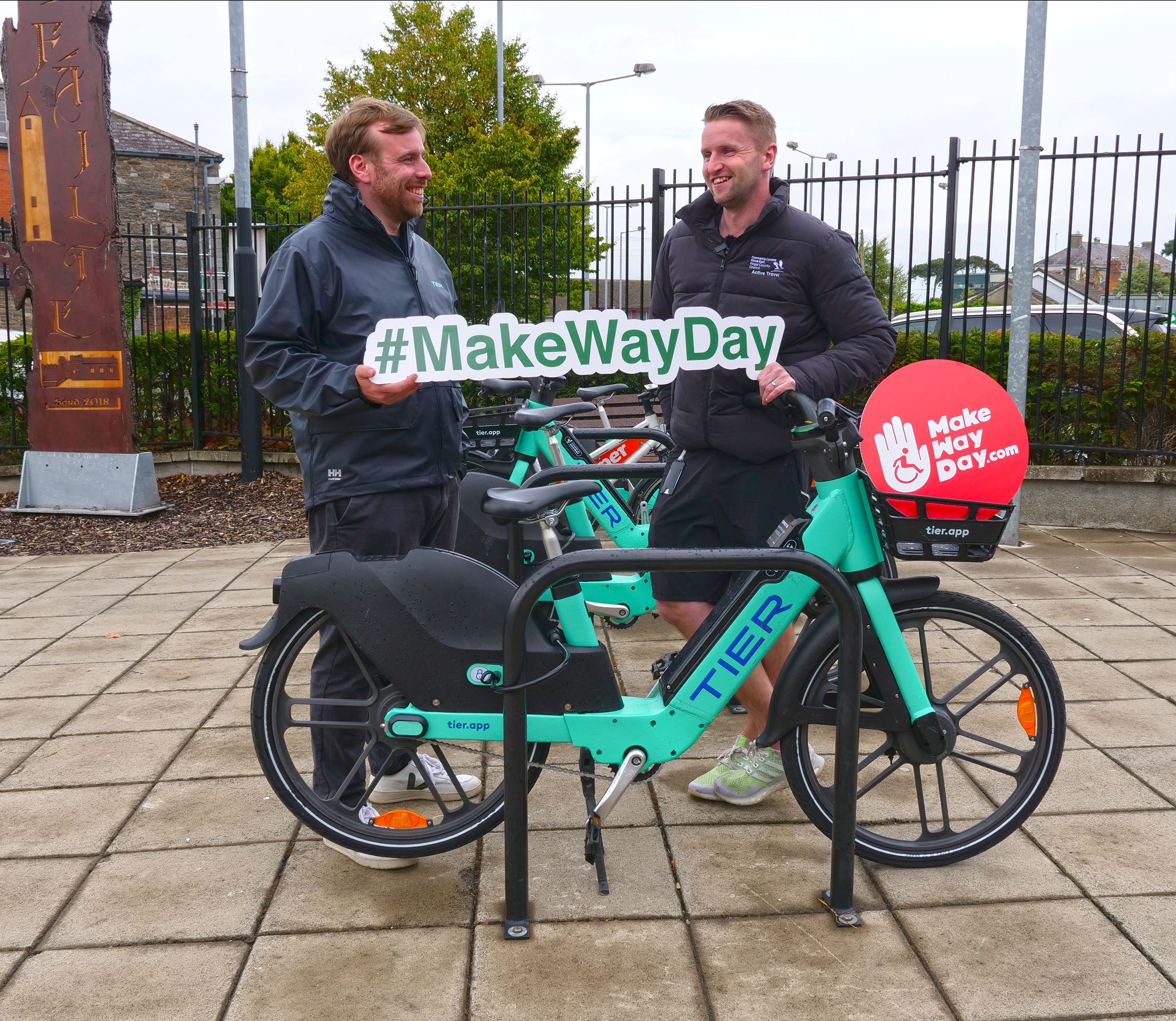 Two men with bike at bike stand