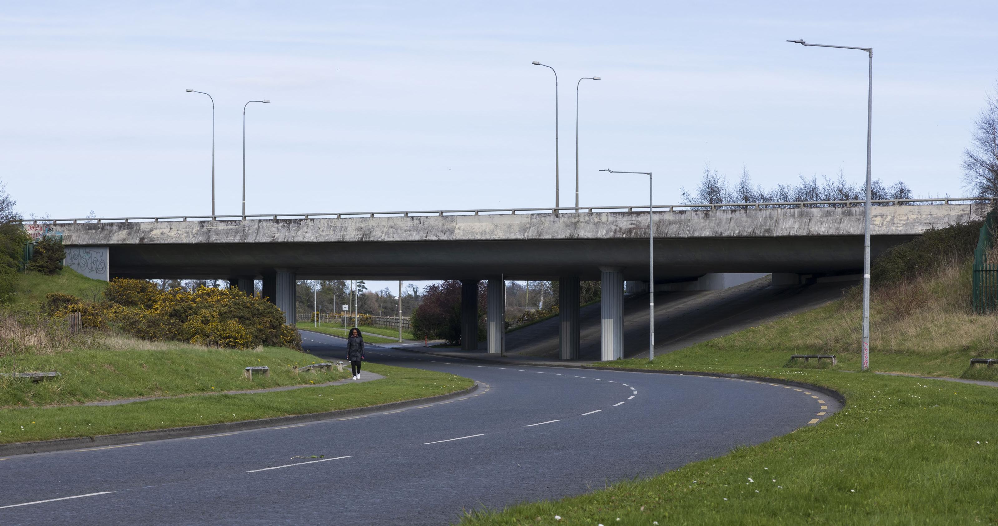 motorway overpass viewed from below with road running under it