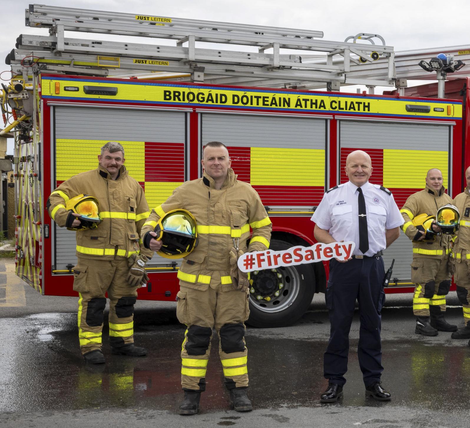 fire officers standing next to tender